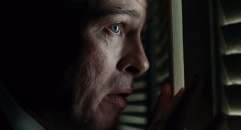 Movie still from “Burn After Reading” (2008), directed by Joel Coen – A person looking out of a window; Extreme Close Up shot, Low angle