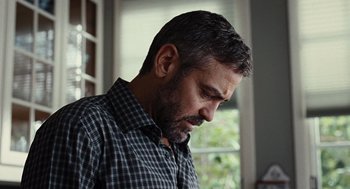 Movie still from “Burn After Reading” (2008), directed by Joel Coen – A person wearing a plaid shirt; Close Up shot, Low angle