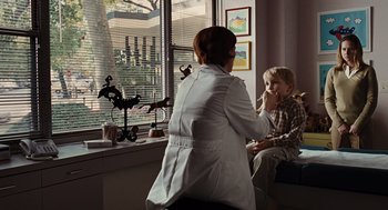 Movie still from “Burn After Reading” (2008), directed by Joel Coen – A woman and a boy sitting in front of a window; Medium shot, Over the shoulder angle