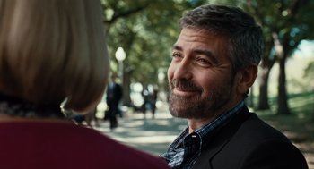 Movie still from “Burn After Reading” (2008), directed by Joel Coen – A person wearing a suit and tie; Close Up shot, Over the shoulder angle