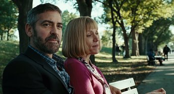 Movie still from “Burn After Reading” (2008), directed by Joel Coen – A man and a woman sitting on a park bench; Close Up shot, Over the shoulder angle
