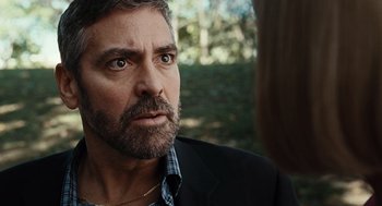 Movie still from “Burn After Reading” (2008), directed by Joel Coen – A person wearing a suit and tie; Close Up shot, Over the shoulder angle