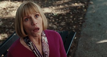 Movie still from “Burn After Reading” (2008), directed by Joel Coen – A person sitting on a park bench; Close Up shot, High angle