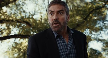 Movie still from “Burn After Reading” (2008), directed by Joel Coen – A person wearing a suit and tie; Close Up shot, Low angle