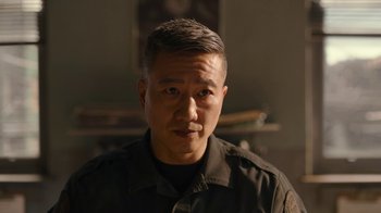 Movie still from “The Last of Us” (2023), created by Neil Druckmann – A person wearing a black shirt; Close Up shot, Over the shoulder angle