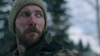 Movie still from “The Last of Us” (2023), created by Neil Druckmann – A person with a beard wearing a hat; Close Up shot, Low angle