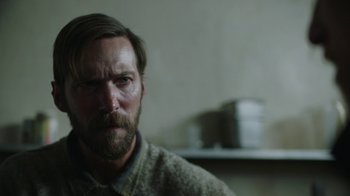 Movie still from “The Last of Us” (2023), created by Neil Druckmann – A person with a beard; Close Up shot, Over the shoulder angle