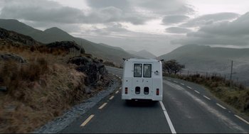 Movie still from “The Lobster” (2015), directed by Yorgos Lanthimos – A bus driving down a road in the mountains; Wide shot, Low angle
