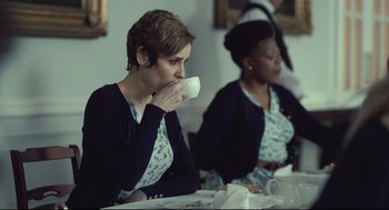 Movie still from “The Lobster” (2015), directed by Yorgos Lanthimos – Two women are sitting at a table drinking coffee; Medium shot, Over the shoulder angle