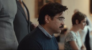 Movie still from “The Lobster” (2015), directed by Yorgos Lanthimos – A man with a mustache wearing glasses and a blue sweater; Close Up shot, Over the shoulder angle