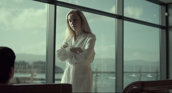 Movie still from “The Lobster” (2015), directed by Yorgos Lanthimos – A woman standing in front of a large window; Medium shot, Low angle