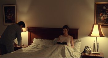 Movie still from “The Lobster” (2015), directed by Yorgos Lanthimos – A woman reading a book in a bed; Wide shot, High angle
