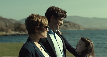 Movie still from “The Lobster” (2015), directed by Yorgos Lanthimos – A man and a woman standing next to each other near a body of water; Medium shot, Over the shoulder angle