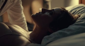 Movie still from “The Lobster” (2015), directed by Yorgos Lanthimos – A woman laying in a bed looking up at the sky; Close Up shot, Low angle