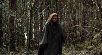 Movie still from “The Lobster” (2015), directed by Yorgos Lanthimos – A woman wearing a cape standing in the woods; Medium shot, Low angle