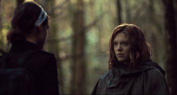Movie still from “The Lobster” (2015), directed by Yorgos Lanthimos – A woman standing next to a man in the woods; Medium shot, Over the shoulder angle