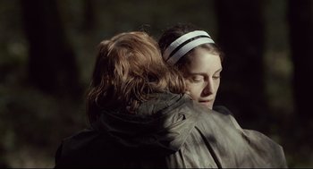 Movie still from “The Lobster” (2015), directed by Yorgos Lanthimos – Two people are hugging each other in the dark; Close Up shot, Over the shoulder angle