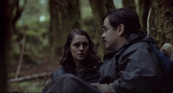 Movie still from “The Lobster” (2015), directed by Yorgos Lanthimos – A man and a woman sitting in the woods; Medium shot, Over the shoulder angle