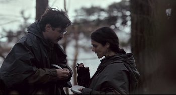 Movie still from “The Lobster” (2015), directed by Yorgos Lanthimos – A man and a woman standing next to each other; Medium shot, Over the shoulder angle