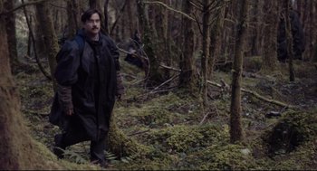 Movie still from “The Lobster” (2015), directed by Yorgos Lanthimos – A man standing in the middle of a forest; Medium shot, Over the shoulder angle