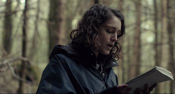 Movie still from “The Lobster” (2015), directed by Yorgos Lanthimos – A woman with curly hair is holding a tablet; Close Up shot, Low angle