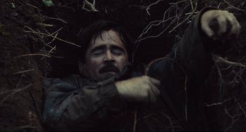 Movie still from “The Lobster” (2015), directed by Yorgos Lanthimos – A man with a beard and mustache is laying in the woods; Close Up shot, Overhead angle