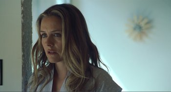 Movie still from “The Lodge” (2019), directed by Severin Fiala – A person with long hair; Close Up shot, Over the shoulder angle