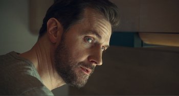 Movie still from “The Lodge” (2019), directed by Severin Fiala – A person with a beard; Close Up shot, Low angle
