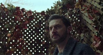 Movie still from “The Lodge” (2019), directed by Severin Fiala – A person wearing a sweater; Close Up shot, Low angle