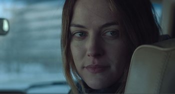 Movie still from “The Lodge” (2019), directed by Severin Fiala – A person with long red hair; Close Up shot, Low angle