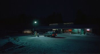 Movie still from “The Lodge” (2019), directed by Severin Fiala – A truck parked in a parking lot at night; Extreme Wide shot, High angle