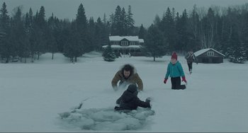 Movie still from “The Lodge” (2019), directed by Severin Fiala – A group of people playing in the snow; Extreme Wide shot, High angle