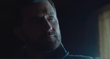 Movie still from “The Lodge” (2019), directed by Severin Fiala – A person with a beard; Close Up shot, Low angle