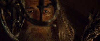 Movie still from “The Lord of the Rings: The Fellowship of the Ring” (2001), directed by Peter Jackson – An old man with long white hair and blue eyes; Close Up shot, High angle