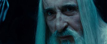 Movie still from “The Lord of the Rings: The Fellowship of the Ring” (2001), directed by Peter Jackson – An old man with long white hair and blue eyes; Close Up shot, Over the shoulder angle