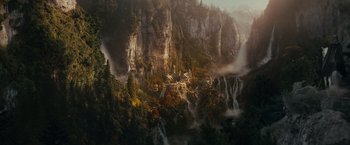 Movie still from “The Lord of the Rings: The Fellowship of the Ring” (2001), directed by Peter Jackson – A painting of a mountain with a waterfall; Extreme Wide shot, High angle