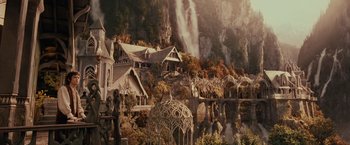 Movie still from “The Lord of the Rings: The Fellowship of the Ring” (2001), directed by Peter Jackson – Many buildings in the middle of a forest; Extreme Wide shot, High angle