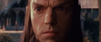 Movie still from “The Lord of the Rings: The Fellowship of the Ring” (2001), directed by Peter Jackson – A man's face in a dimly - lit room; Close Up shot, Low angle