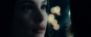Movie still from “The Lord of the Rings: The Fellowship of the Ring” (2001), directed by Peter Jackson – A woman's face in front of lights; Close Up shot, Over the shoulder angle