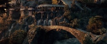 Movie still from “The Lord of the Rings: The Fellowship of the Ring” (2001), directed by Peter Jackson – A bridge that has a bunch of people on it; Extreme Wide shot, High angle