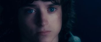 Movie still from “The Lord of the Rings: The Fellowship of the Ring” (2001), directed by Peter Jackson – A person's face with blue eyes; Close Up shot, Over the shoulder angle