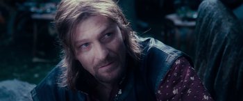 Movie still from “The Lord of the Rings: The Fellowship of the Ring” (2001), directed by Peter Jackson – A person with long brown hair; Close Up shot, Over the shoulder angle