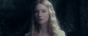 Movie still from “The Lord of the Rings: The Fellowship of the Ring” (2001), directed by Peter Jackson – A person with long blonde hair; Close Up shot, Over the shoulder angle