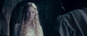 Movie still from “The Lord of the Rings: The Fellowship of the Ring” (2001), directed by Peter Jackson – A woman with long blonde hair wearing a white dress; Close Up shot, Over the shoulder angle