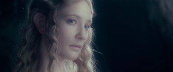 Movie still from “The Lord of the Rings: The Fellowship of the Ring” (2001), directed by Peter Jackson – A person with long blonde hair; Close Up shot, Over the shoulder angle