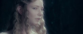 Movie still from “The Lord of the Rings: The Fellowship of the Ring” (2001), directed by Peter Jackson – A beautiful young woman with long blonde hair; Close Up shot, Over the shoulder angle