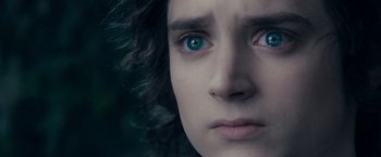Movie still from “The Lord of the Rings: The Fellowship of the Ring” (2001), directed by Peter Jackson – A person's face with blue eyes; Close Up shot, Over the shoulder angle