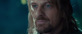 Movie still from “The Lord of the Rings: The Fellowship of the Ring” (2001), directed by Peter Jackson – A person with long hair and blue eyes; Close Up shot, Over the shoulder angle