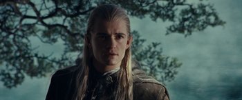 Movie still from “The Lord of the Rings: The Fellowship of the Ring” (2001), directed by Peter Jackson – A man with long blonde hair wearing a brown jacket; Close Up shot, Low angle