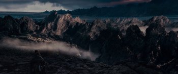Movie still from “The Lord of the Rings: The Fellowship of the Ring” (2001), directed by Peter Jackson – A view of a mountain range in the dark; Extreme Wide shot, High angle
